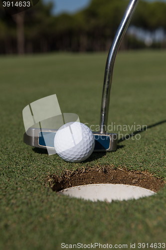 Image of hitting golf ball to hole