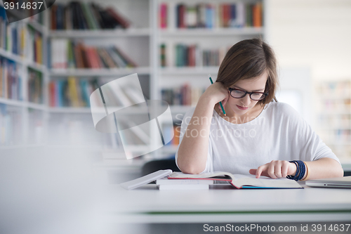 Image of female student study in school library
