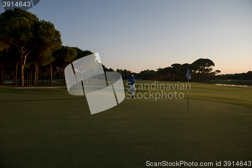 Image of golfer hitting ball to hole