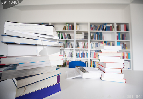 Image of female student study in library, using tablet and searching for 