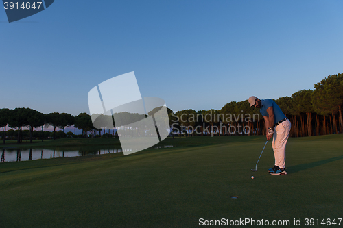 Image of golfer  hitting shot at golf course