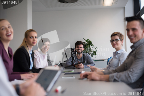 Image of close up of  businessman hands  using tablet on meeting