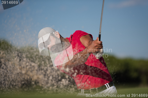 Image of golfer hitting a sand bunker shot