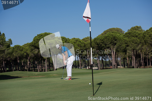 Image of golf player hitting shot at sunny day