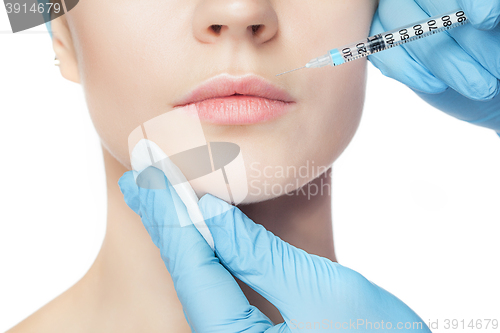 Image of Attractive woman at plastic surgery with syringe in her face