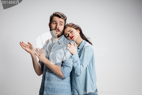 Image of The young couple with different emotions during conflict