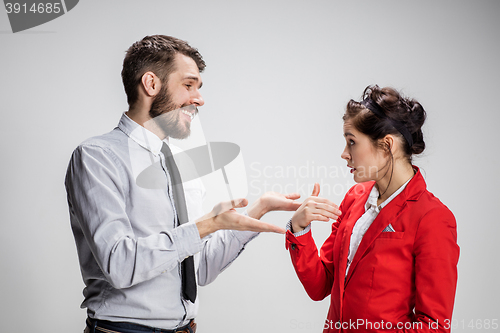 Image of The business man and woman communicating on a gray background