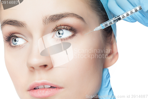 Image of Attractive woman at plastic surgery with syringe in her face