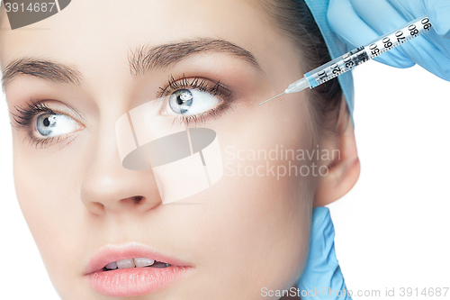 Image of Attractive woman at plastic surgery with syringe in her face