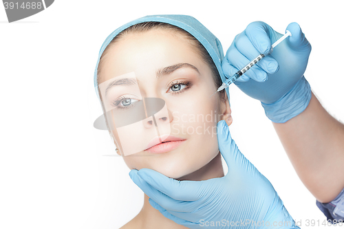 Image of Attractive woman at plastic surgery with syringe in her face