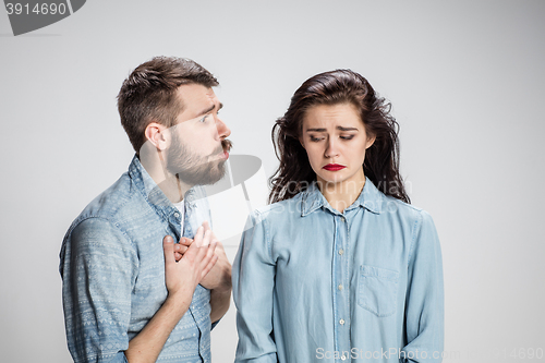 Image of The young couple with different emotions during conflict