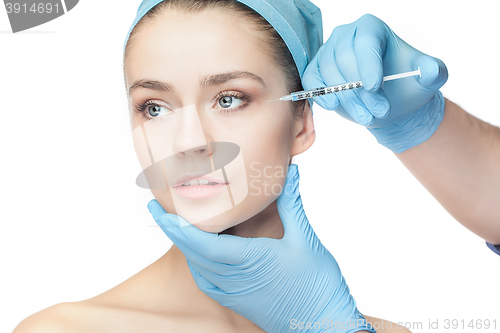 Image of Attractive woman at plastic surgery with syringe in her face