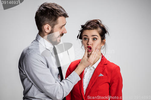 Image of The angry business man and woman conflicting on a gray background