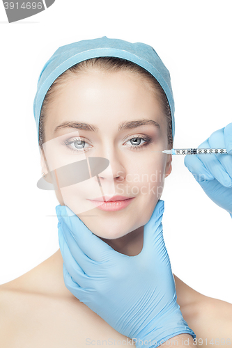 Image of Attractive woman at plastic surgery with syringe in her face