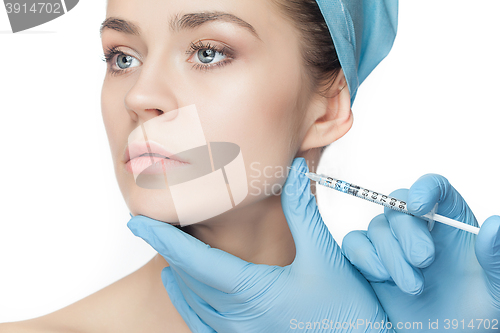 Image of Attractive woman at plastic surgery with syringe in her face