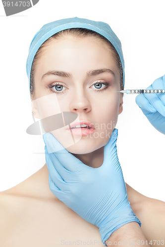 Image of Attractive woman at plastic surgery with syringe in her face