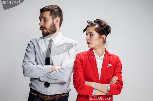 Image of The sad business man and woman conflicting on a gray background