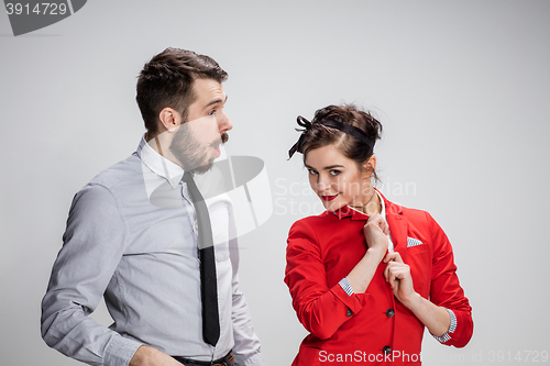 Image of The business man and woman communicating on a gray background