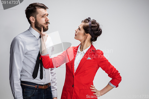 Image of The business man and woman communicating on a gray background