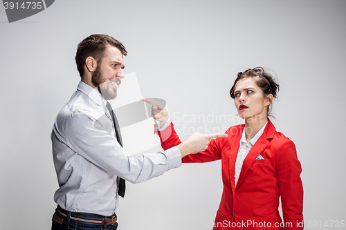 Image of The business man and woman conflicting on a gray background