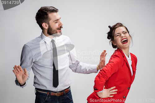Image of The business man and woman communicating on a gray background