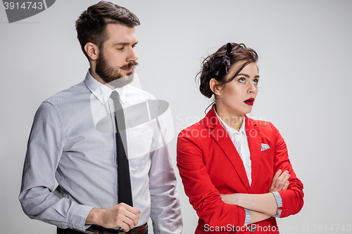 Image of The business man and woman communicating on a gray background