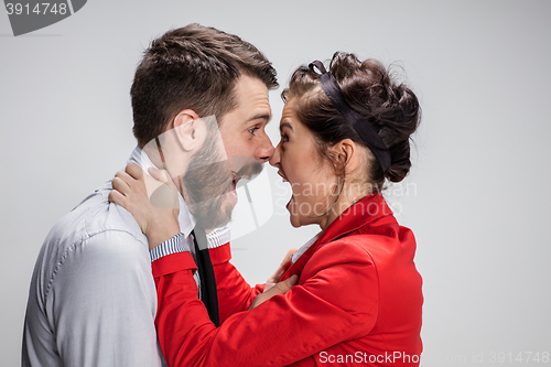 Image of The business man and woman conflicting on a gray background