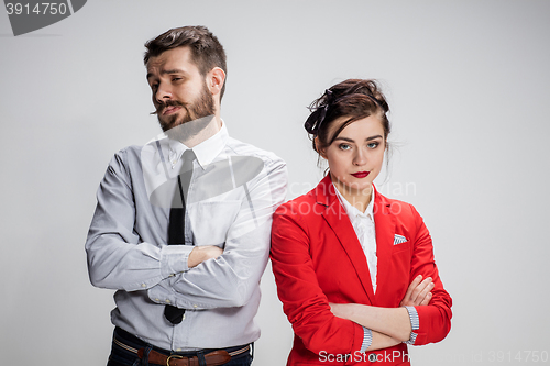 Image of The sad business man and woman conflicting on a gray background