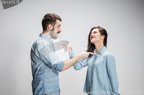 Image of The young couple with different emotions during conflict