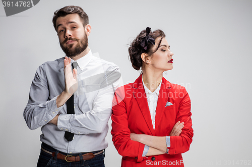 Image of The sad business man and woman conflicting on a gray background