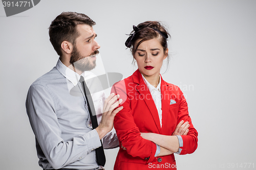 Image of The business man and woman communicating on a gray background