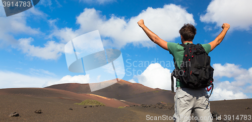 Image of Man reaching the top of mountain.