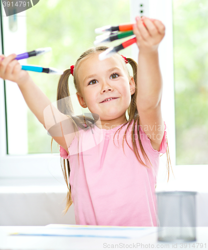 Image of Cute cheerful child drawing using felt-tip pen