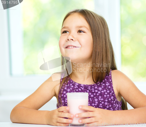 Image of Cute little girl showing milk moustache