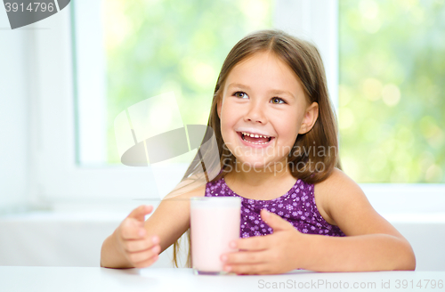 Image of Cute little girl with a glass of milk