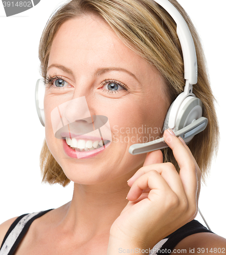 Image of Lovely young woman is talking to customers