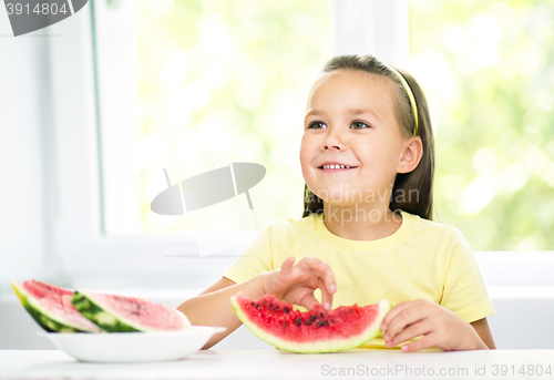 Image of Cute little girl is eating watermelon