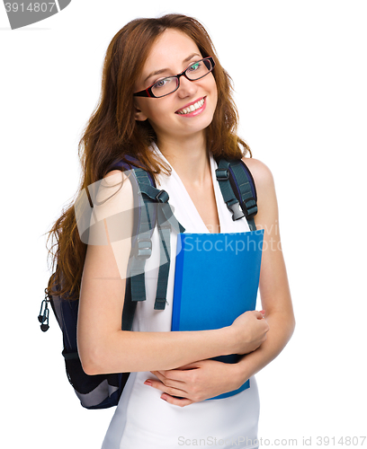 Image of Young student girl is holding book