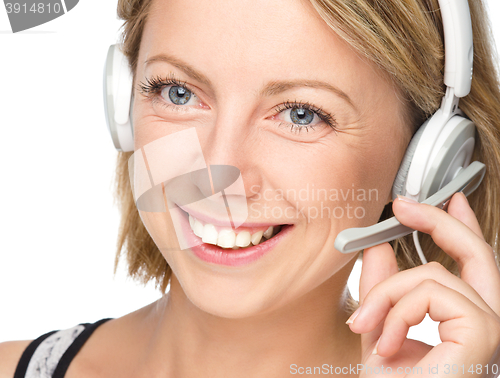 Image of Lovely young woman is talking to customers
