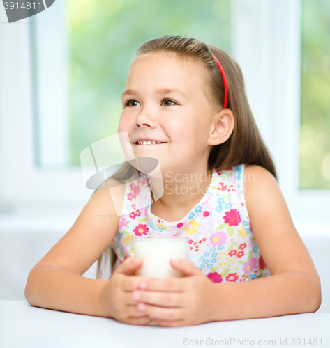 Image of Cute little girl with a glass of milk