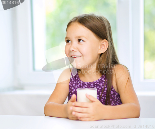 Image of Cute little girl with a glass of milk