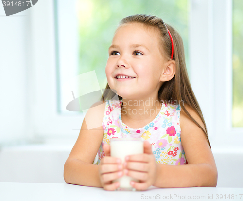 Image of Cute little girl with a glass of milk