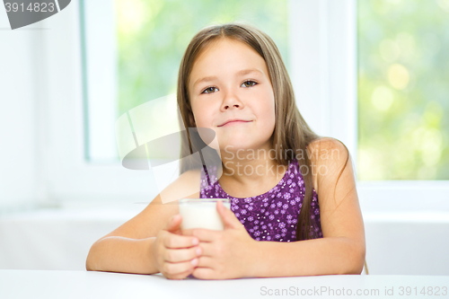 Image of Cute little girl with a glass of milk