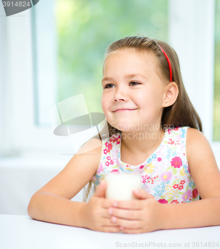 Image of Cute little girl with a glass of milk