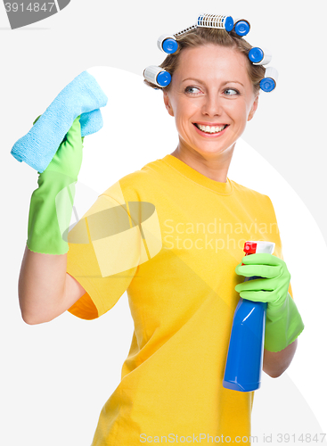 Image of Young woman is cleaning glass using rag