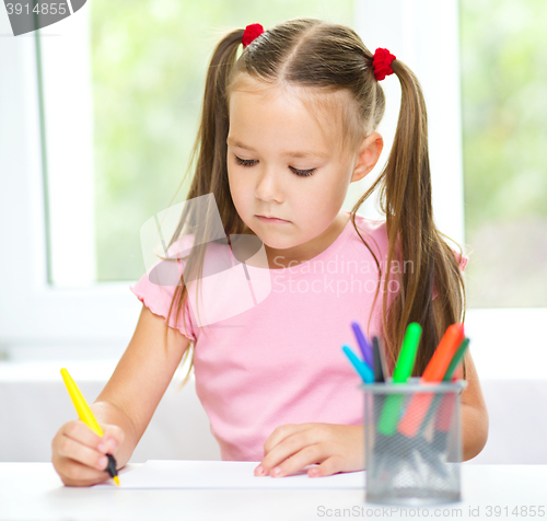 Image of Cute cheerful child drawing using felt-tip pen