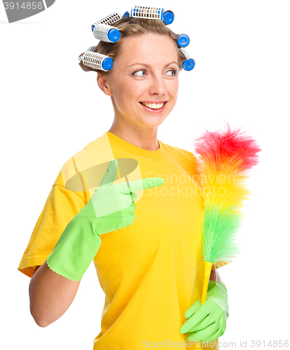 Image of Young woman with curlers and static duster