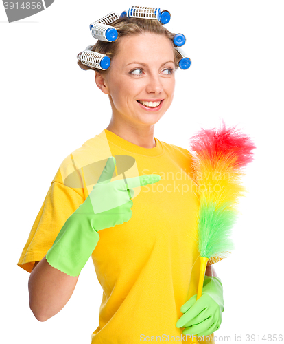 Image of Young woman with curlers and static duster