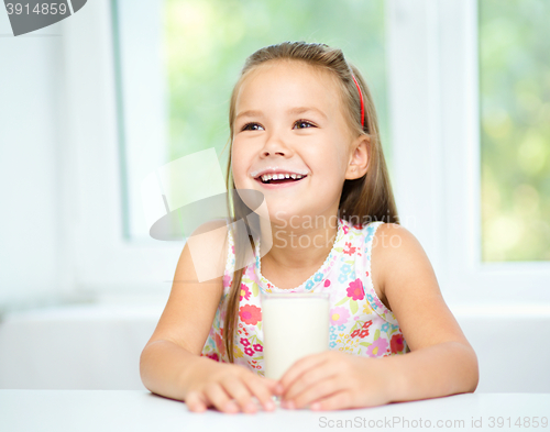 Image of Cute little girl with a glass of milk