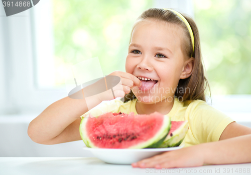 Image of Cute little girl is eating watermelon